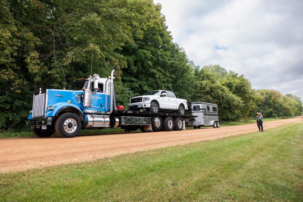 a pickup truck and trailer being towed by USRider roadside assistance