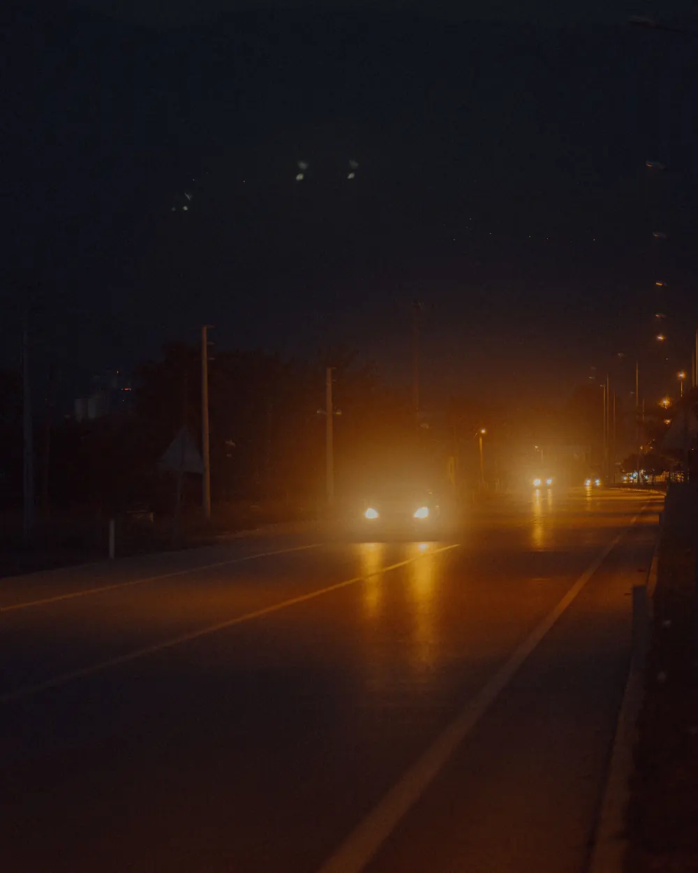 Headlights on a road at night